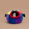 cat peeking out of balloonfish bed