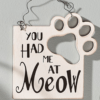 white sign with cat paw print